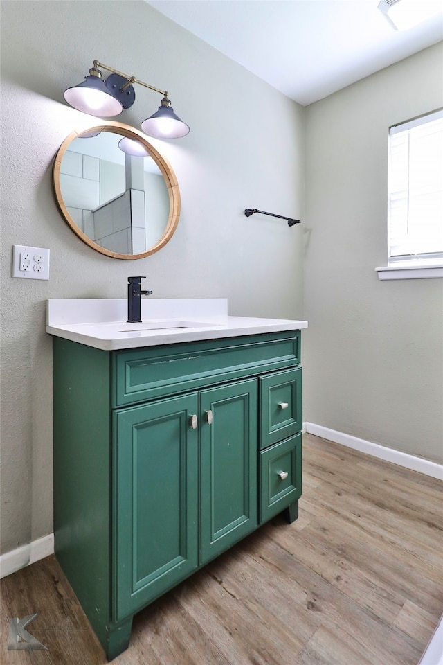 bathroom with hardwood / wood-style floors and vanity