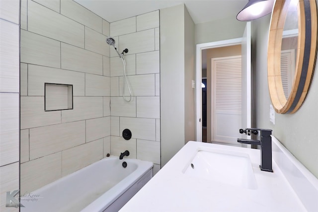 bathroom featuring vanity and tiled shower / bath combo