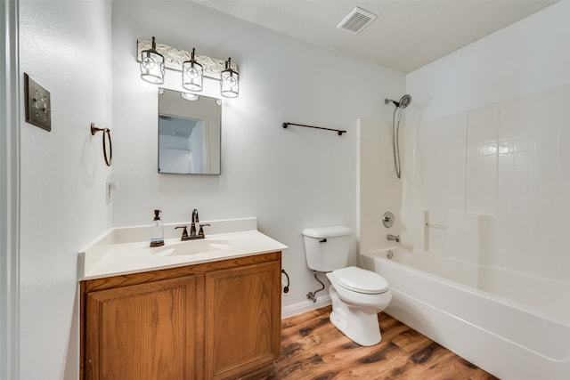 full bathroom featuring vanity, wood-type flooring, shower / bathtub combination, and toilet