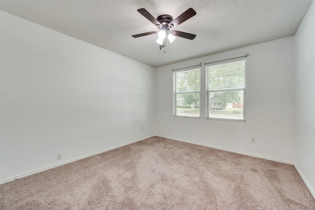 unfurnished room featuring carpet flooring, ceiling fan, and a textured ceiling