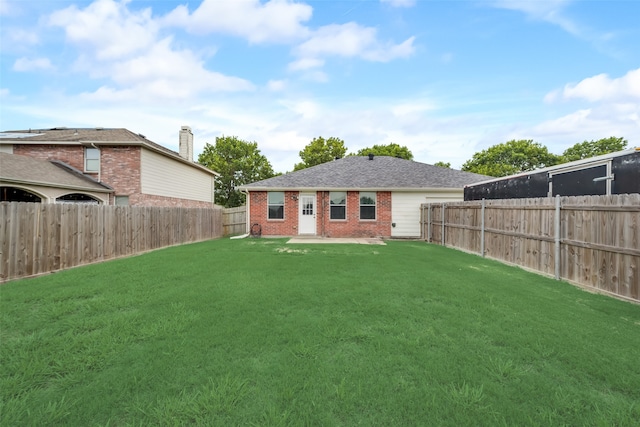 back of house featuring a lawn