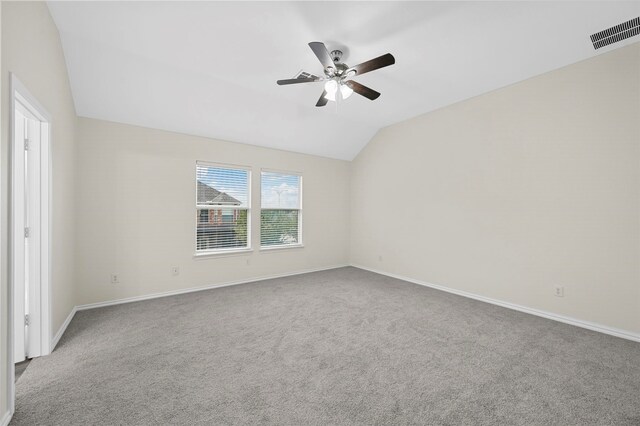 unfurnished room with ceiling fan, vaulted ceiling, and carpet