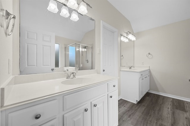 bathroom featuring vanity, lofted ceiling, hardwood / wood-style floors, and a shower with door