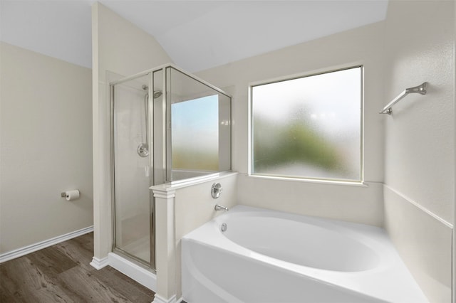 bathroom featuring hardwood / wood-style floors, lofted ceiling, and separate shower and tub