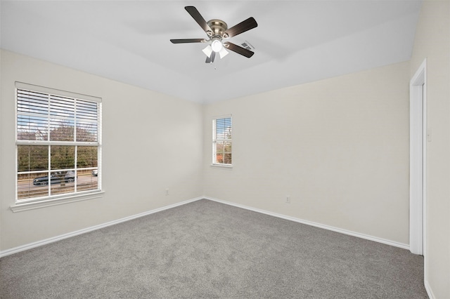 carpeted spare room featuring ceiling fan