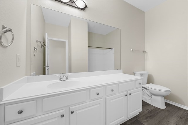 bathroom with a shower, wood-type flooring, vanity, and toilet