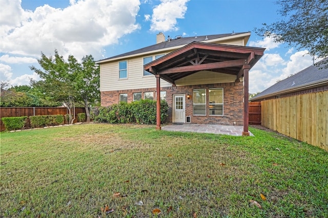 back of property featuring a patio and a yard