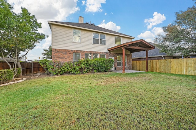 rear view of property with a yard