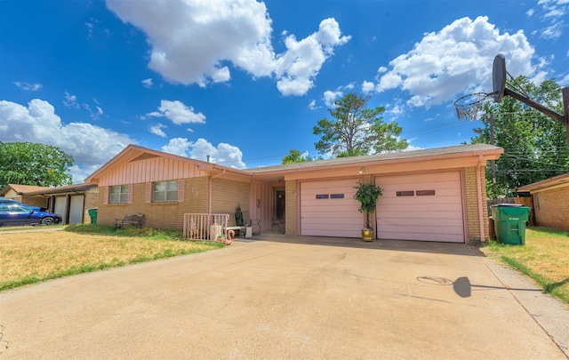 ranch-style home with a garage and a front yard