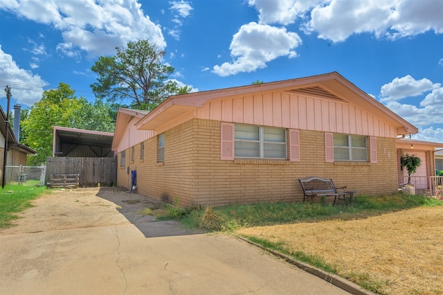 view of home's exterior featuring a carport and a yard