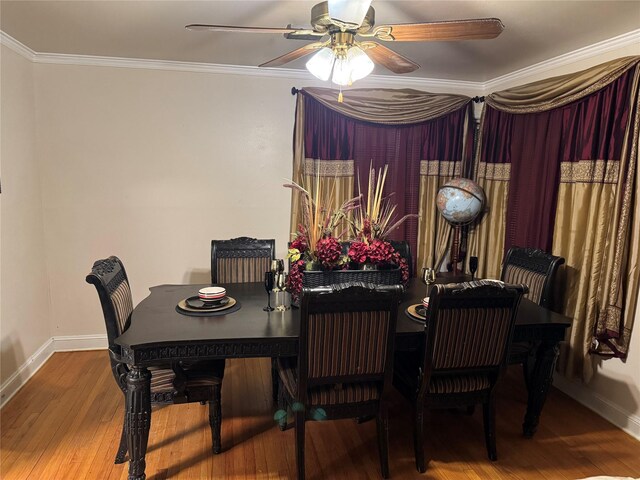 dining space featuring hardwood / wood-style flooring, ornamental molding, and ceiling fan