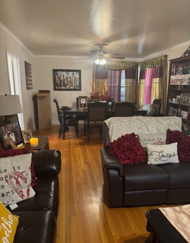 living room featuring crown molding, ceiling fan, and hardwood / wood-style flooring