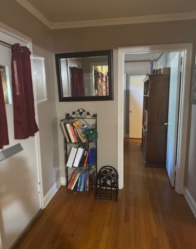 corridor featuring wood-type flooring and ornamental molding