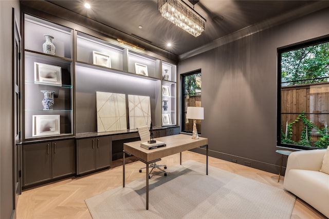 home office featuring ornamental molding, a chandelier, and light parquet flooring