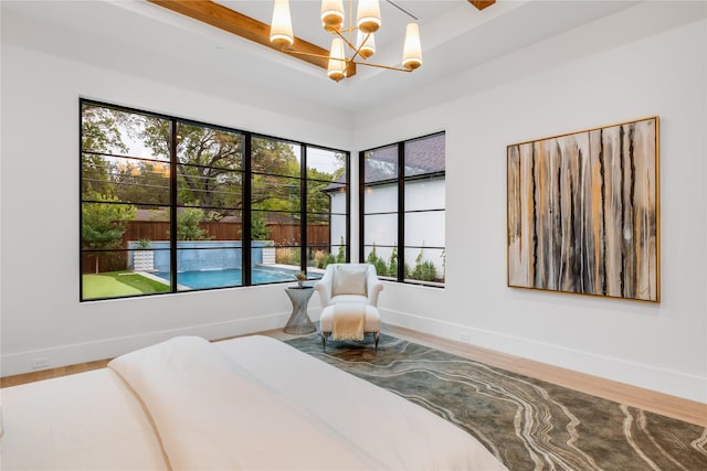 bedroom with hardwood / wood-style flooring and a chandelier