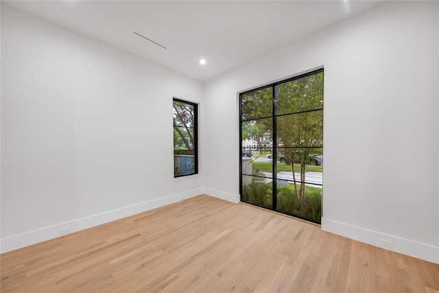 unfurnished room with light hardwood / wood-style flooring