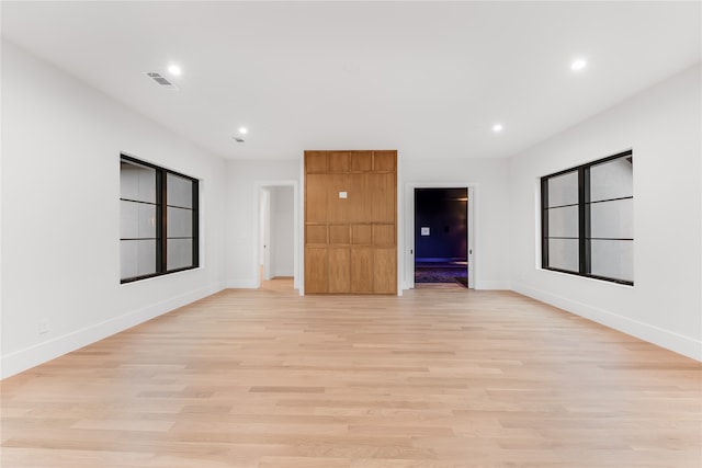 unfurnished room with light wood-type flooring