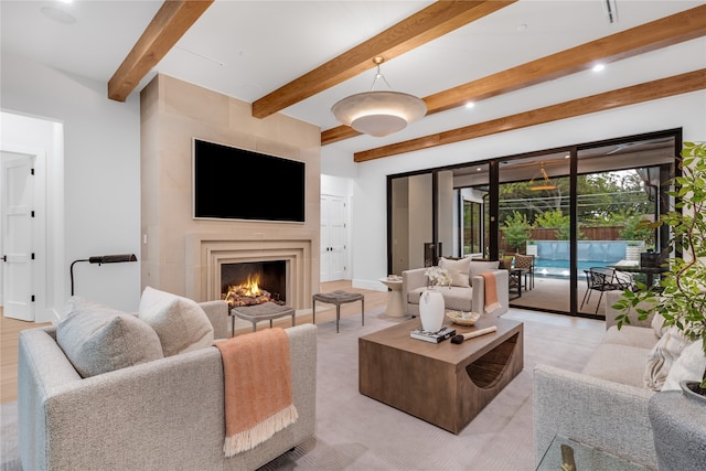 living room with a fireplace, light hardwood / wood-style floors, and beam ceiling