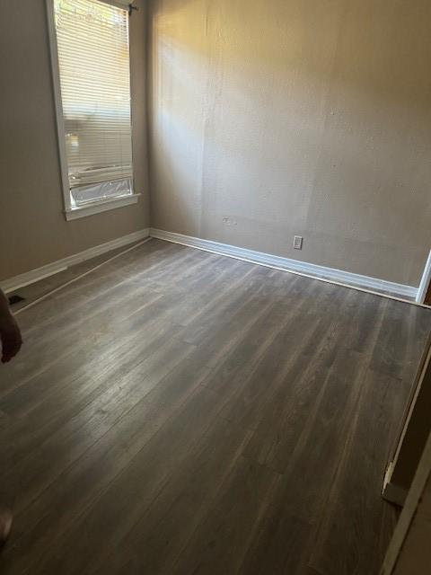 unfurnished room featuring dark hardwood / wood-style flooring