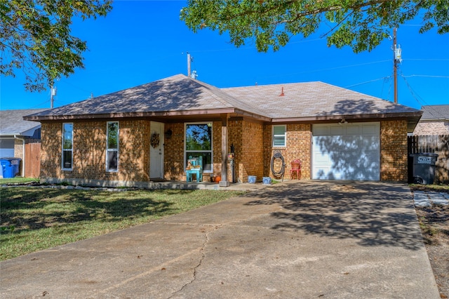 ranch-style home with a garage and a front lawn