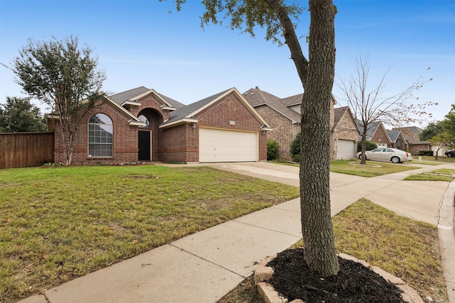 view of front of property featuring a garage and a front lawn