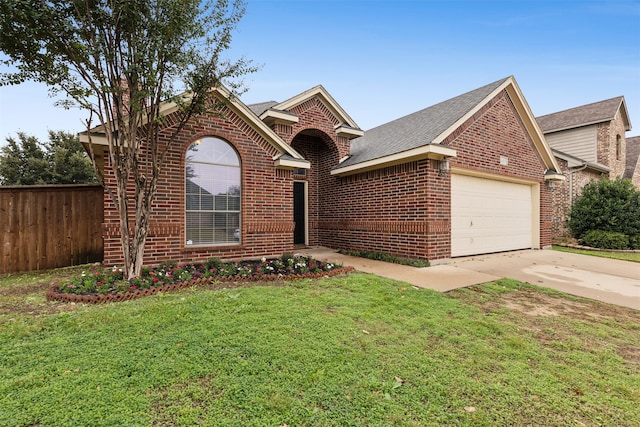 view of front of property with a garage and a front yard