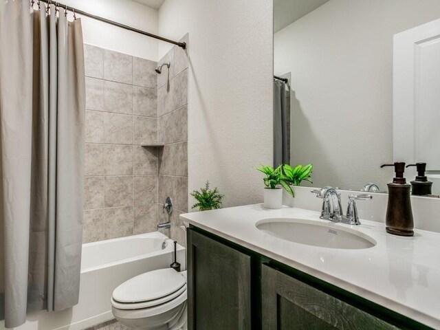 full bathroom featuring toilet, vanity, and shower / bathtub combination with curtain