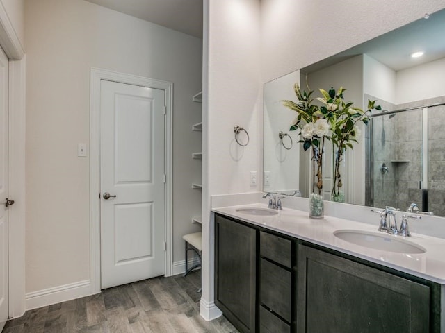 bathroom featuring wood-type flooring, vanity, and a shower with door