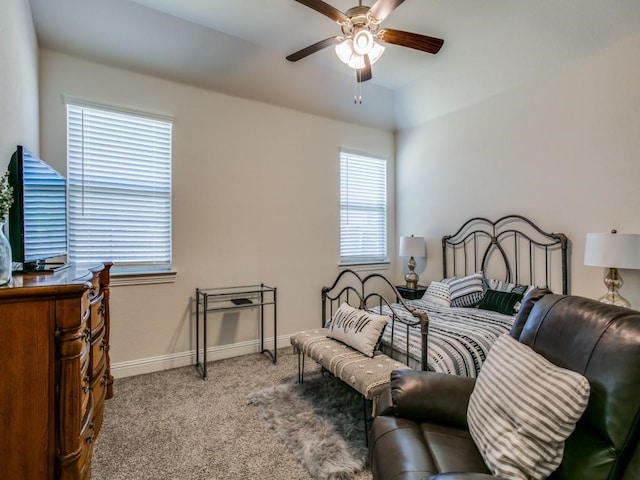 bedroom featuring light colored carpet, multiple windows, and ceiling fan