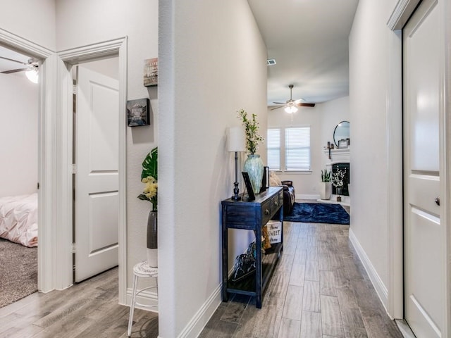 hall with hardwood / wood-style floors