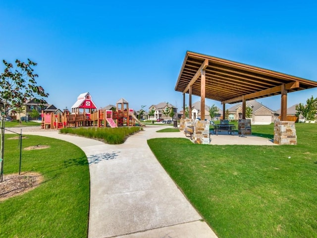 view of property's community with a playground and a yard