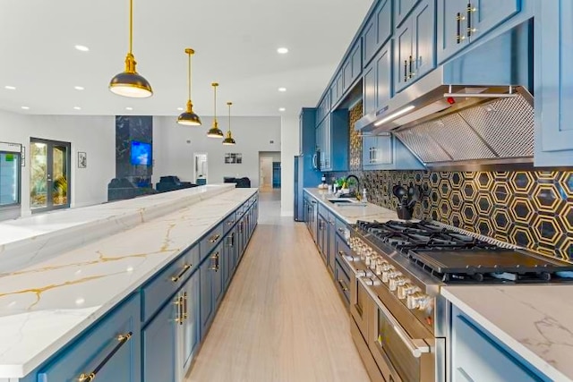 kitchen featuring blue cabinetry, stainless steel range, light stone counters, light hardwood / wood-style floors, and decorative light fixtures