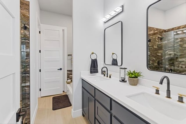 bathroom featuring hardwood / wood-style floors, vanity, and an enclosed shower