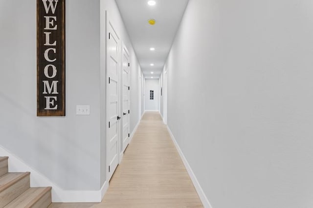 hallway with light hardwood / wood-style flooring