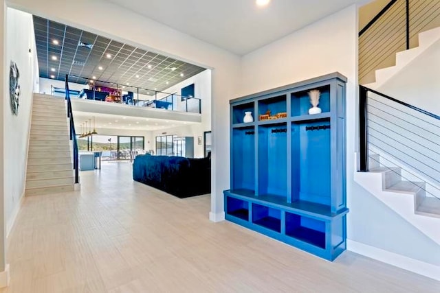 interior space with wood-type flooring and a high ceiling