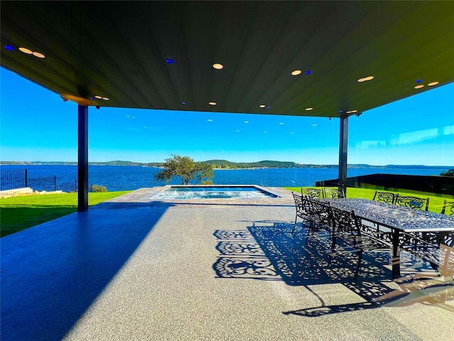 view of patio with a water and mountain view