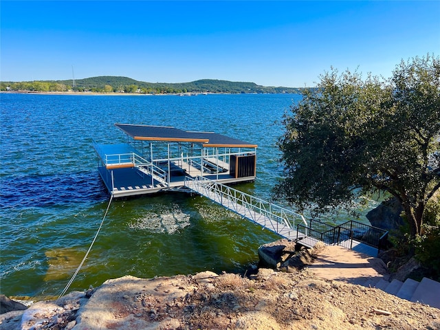 view of dock with a water and mountain view