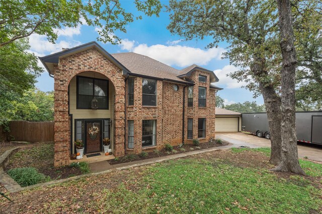 view of front of property featuring a garage and a front lawn