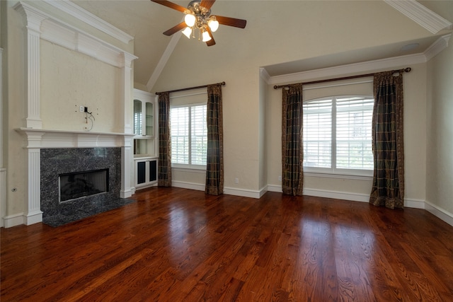 unfurnished living room with ornamental molding, a premium fireplace, dark wood-type flooring, lofted ceiling, and ceiling fan