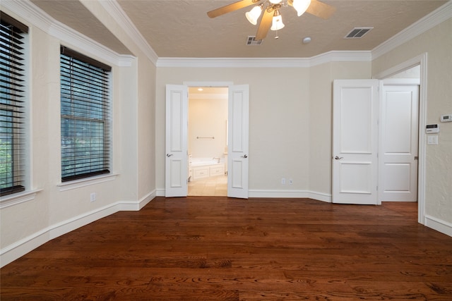 unfurnished bedroom with ceiling fan, dark hardwood / wood-style floors, a textured ceiling, and crown molding