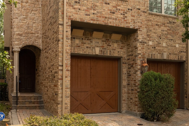 view of exterior entry with a garage