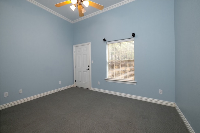 empty room with dark colored carpet, ceiling fan, crown molding, and vaulted ceiling