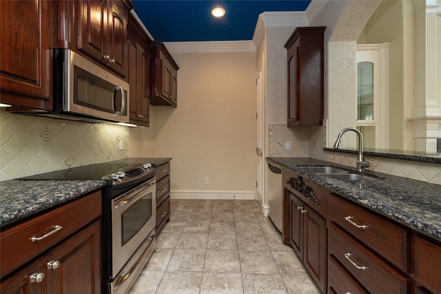 kitchen featuring stainless steel appliances, sink, tasteful backsplash, dark stone counters, and crown molding