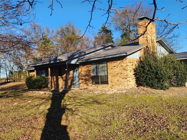 rear view of property with a yard and a patio