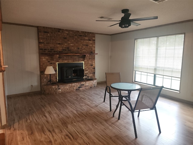 dining area with hardwood / wood-style floors, ceiling fan, and crown molding