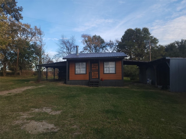 view of front facade with a carport, entry steps, and driveway