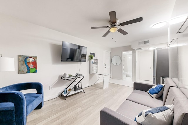 living room featuring ceiling fan and light hardwood / wood-style flooring