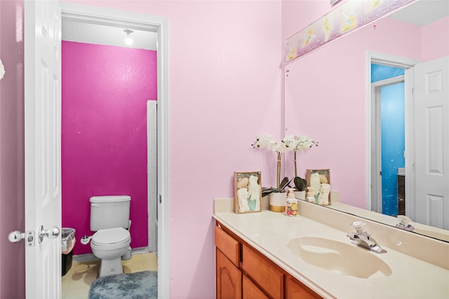 bathroom featuring toilet and vanity