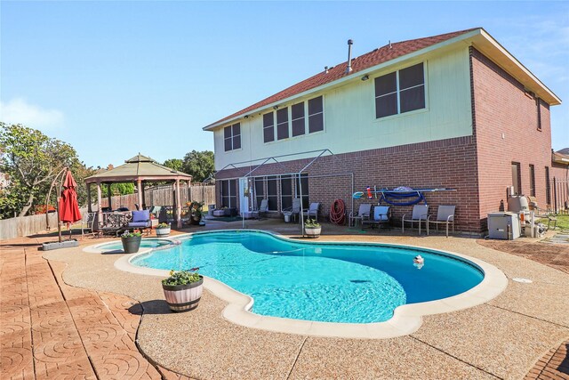 view of pool with a patio area and a gazebo