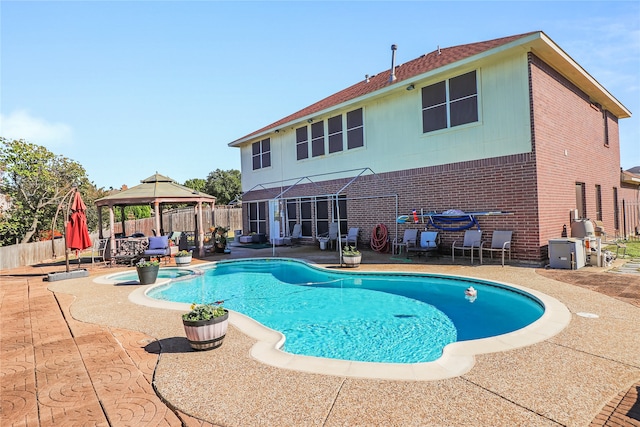 view of swimming pool featuring a patio and a gazebo